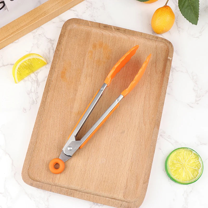 Oranje siliconen keukentang op houten plank – opvallend design, hittebestendig en veilig voor elke pan of grilloppervlak.